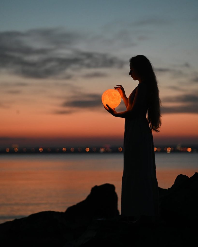 a woman holding an orb