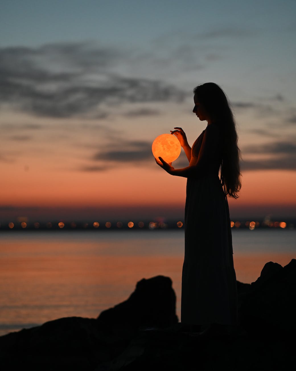 a woman holding an orb
