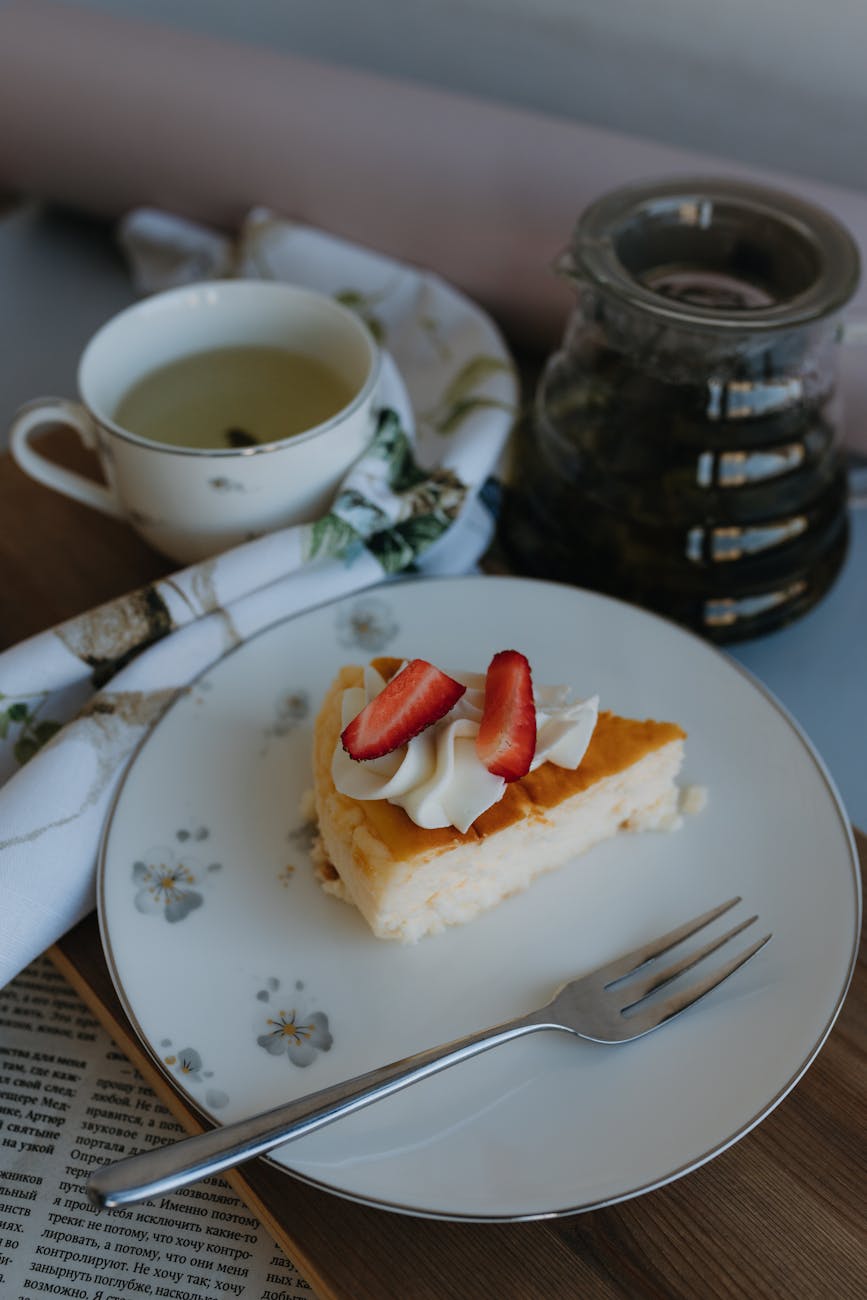 piece of cheesecake topped with whipped cream and strawberry